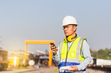 Engineer man in waistcoats and hardhats in a railway depot, Engineer under inspection and checking...