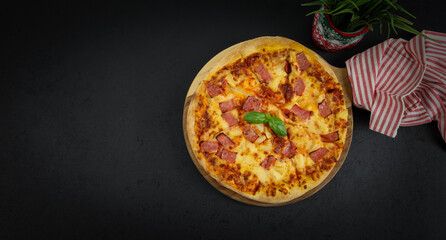 Round baked pizza on a wooden cutting board