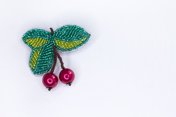a brooch for clothes from a bead. bead product. cherry brooch. accessories for women. - obrazy, fototapety, plakaty
