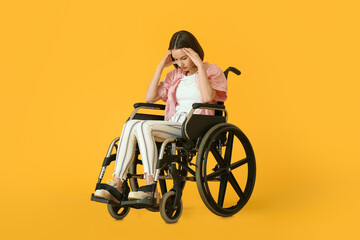 Fototapeta na wymiar Sad young woman in wheelchair on color background