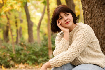 Beautiful brooding woman in autumn park