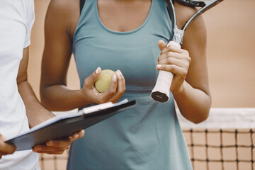 Two tennis players reading a rules before the match