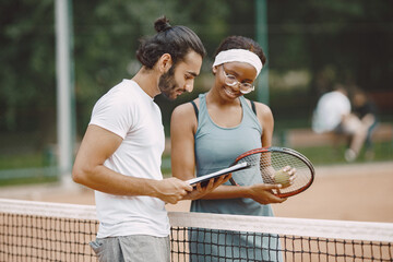 Two tennis players reading a rules before the match