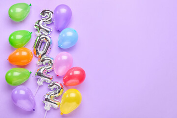 Composition with figure 2022 and different balloons on color background