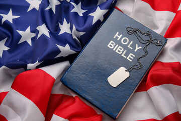 Bible and military tag on flag of USA