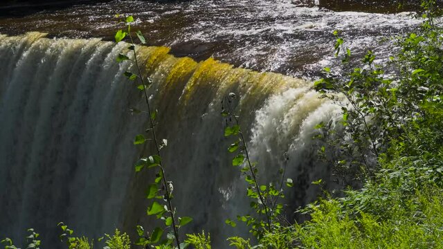 Waterfall drop-off point - force of water rushing off a cliff--late afternoon in late summer--Tahquamenon Higher Falls.