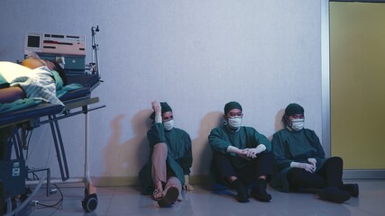 Tired doctor, Group of surgery doctors sadness fatigue after surgery, emotional sitting stress of overworked doctor and medical care team during covid-10, Surgical team tired after operation