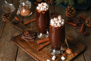 Glasses of tasty hot chocolate with marshmallows on wooden background