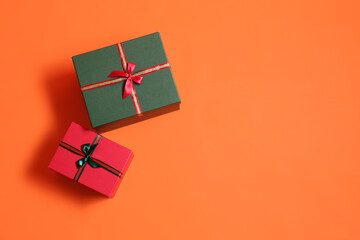 Beautiful Christmas gift boxes on orange background