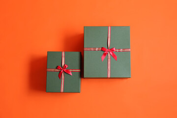 Beautiful Christmas gift boxes on orange background
