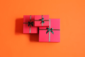 Beautiful Christmas gift boxes on orange background