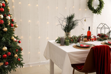 Dining table with beautiful setting for Christmas celebration in festive room