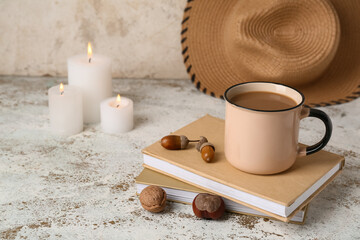 Obraz na płótnie Canvas Cup of tasty coffee and books on light background