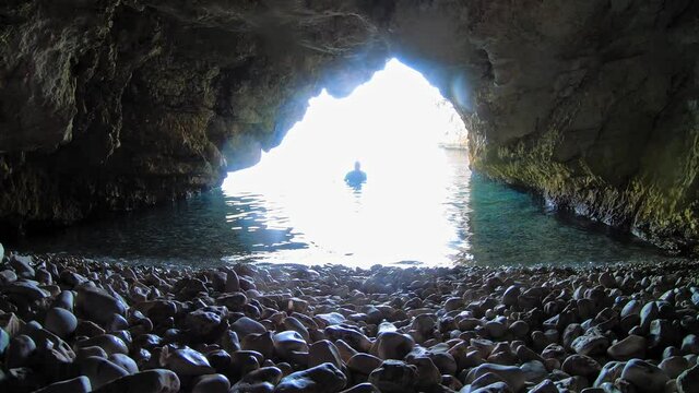 Man Rising In The Water Inside The Cave In Kefalonia Island, Greece. wide