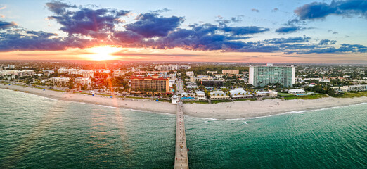 aerial drone of sunset over Deerfield Beach, Florida with city and beach