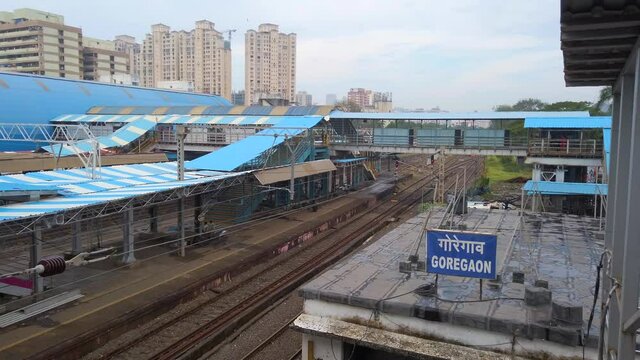 empty goregaon railway station mumbai india near road in winter rain blue sky cloudes cityscape  rikshaw on road  in covid pendamic  omicron lockdown.