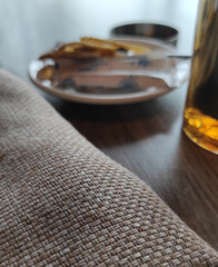 Canvas napkin on the table against the background of a cup of tea 