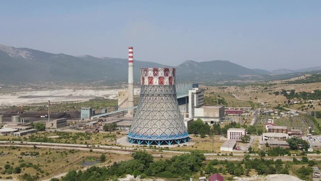 Coal Thermal Power Plant and Open Mine Pit, Aerial View of Chimney and a Cooling Tower on Sunny Summer Day. Gacko, Bosnia and Herzegovina, Drone Shot