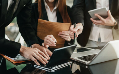 Group of financial advisors sitting at the table and listening to their manager during a meeting at office in the morning.