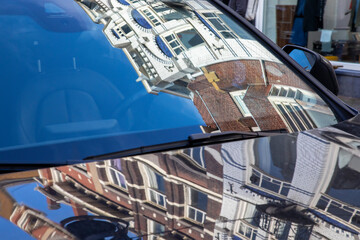 Europe, Netherlands, The Hague. Distorted reflections of buildings on a car.