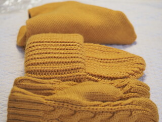 a set of warm yellow clothes. hat mittens and scarf