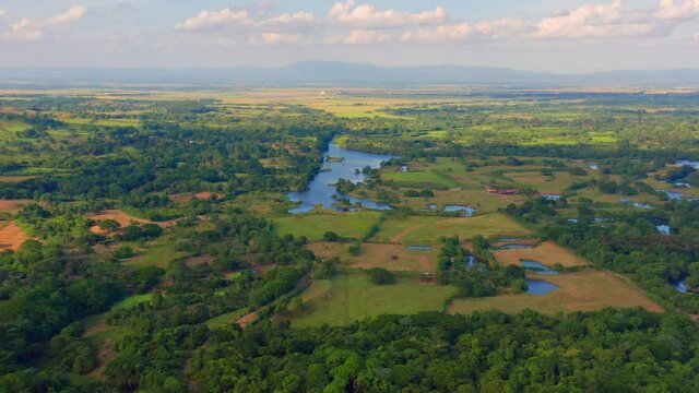 Panoramic View On Lush Green Vegetation Surrounding Hatillo Dam In Dominican Republic - aerial drone shot