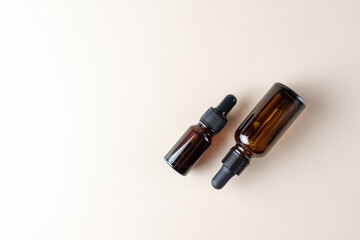 facial essential oil or serum packaging on beige Background. Beauty cosmetic product for skincare concept copy space.