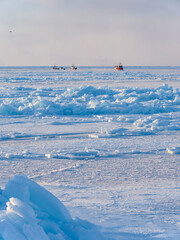 Ships in the sea ice of the frozen Disko Bay during winter, West Greenland, Denmark