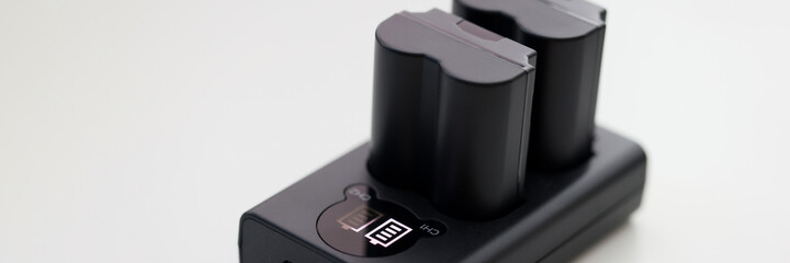 Closeup of black camera battery charger with cable