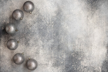 Christmas decoration with shiny silver balls on a gray background. Top view.