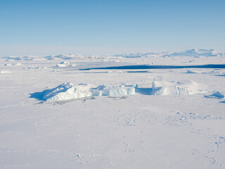 Sea ice with icebergs in the Baffin Bay, between Kullorsuaq and Upernavik in the far north of Greenland during winter.