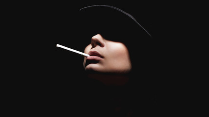 Beautiful woman in a hat and with a cigarette