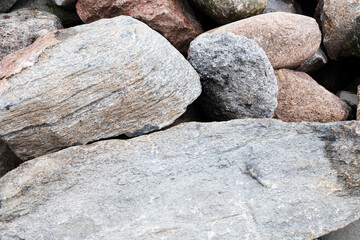 Rockfall on the road in the mountains. Stones of different sizes. Landslides.