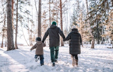 Family walking in winter forest