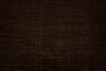 Natural linen fabric, background or texture, toned in brown color, top view, close up