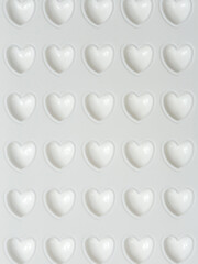 White hearts wallpaper background. Pink 3D hearts on white background. Happy Valentines Day. Texture with three-dimensional hearts. Copy space. Place for your text.