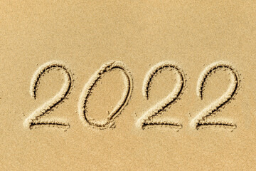 new year 2022 written in sand