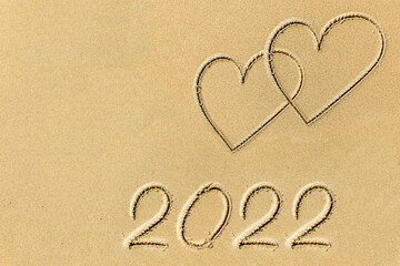 Heart symbol painted on sand