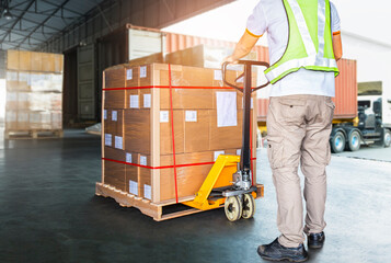 Worker Courier Using Hand Pallet Jack Unloading Package Boxes into Cargo Container. Delivery service. Truck Loading at Dock Warehouse. Supply Chain Shipments. Shipping Cargo Transport. Logistics 