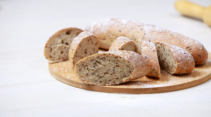 Bread on a cutting Board. Whole-grain rye bread. On light wooden table