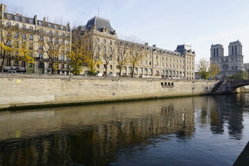  view and reflection in seine river of notre dame cathedral and buildings  paris france in fall