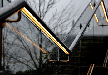 from the bottom of the handle is a recessed LED strip with a yellow light. the side of the stair...