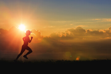 Woman running alone at beautiful sunset in the valley. Summer sport and healthy concept.