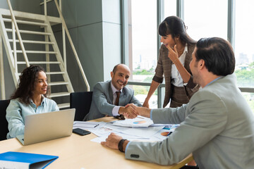 Business team discussing together business plans in the meeting room.