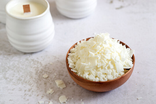 Soy Wax Flakes Ingredient For Homemade Candle Making In Wooden Bowl.