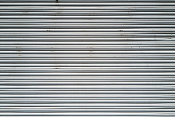 Obraz premium Linear patterns on a corrugated metal garage door