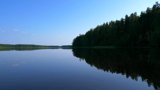 Reflection on the lake and the forest is near