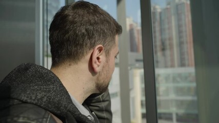close up of caucasian businessman talking on the mobile phone in the descent elevator at urban city office building