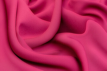 Close-up texture of natural red or pink or fuchsia fabric or cloth in same color. Fabric texture of...