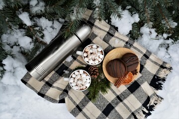 Winter picnic in the forest. Picnic basket in the snow. Winter holidays	